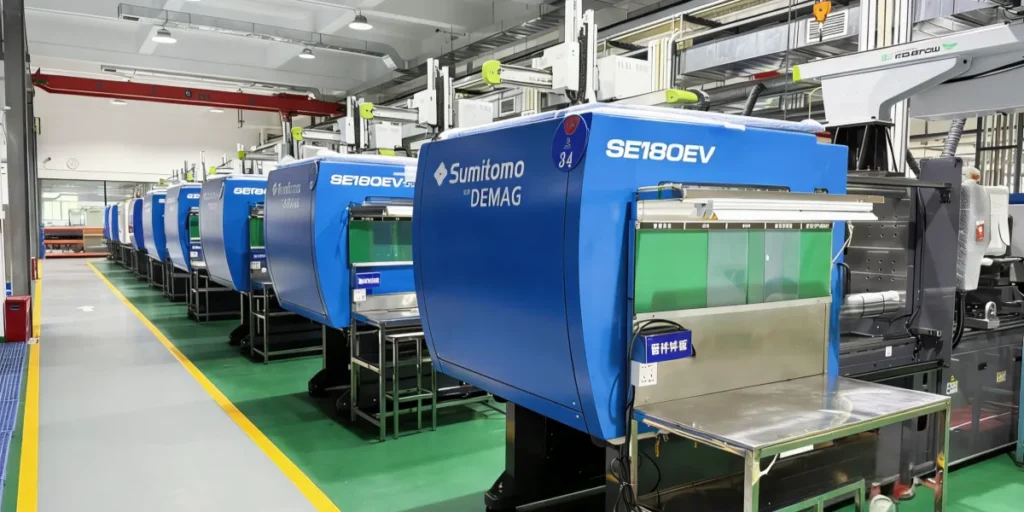 Longitudinal view of a modern injection molding production aisle at YG TeCH, demonstrating high-capacity mass production capabilities for phone cases.
